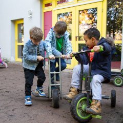 Das Bild zeigt spielende Kinder auf dem Außengelände der Kita Hübenbusch